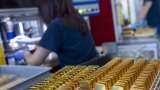 Gold gains as dollar, yields slip ahead of US inflation data