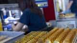 Gold gains as dollar, yields slip ahead of US inflation data