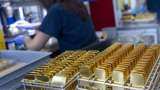 Gold scales 1-month peak as dollar, yields drop on rate-hike pause hopes