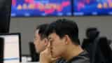 Asia stocks skid on weak China data, yen dives as BOJ tweaks yield control