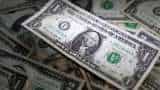 Dollar hovers near 2-1/2-month lows, easing pressure on yen