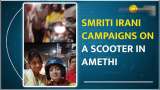 BJP&#039;s Smriti Irani Engages with Amethi Locals, Rides Scooter in Election Campaign
