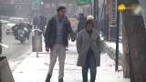 People sit around bonfire as temperature in Srinagar continues to remain below freezing point