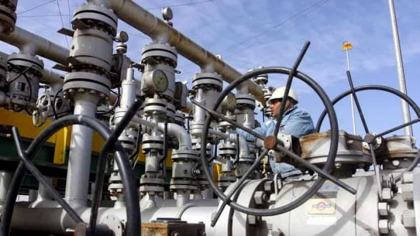 Crude oil falls towards $49 per barrel on high output, strong dollar 