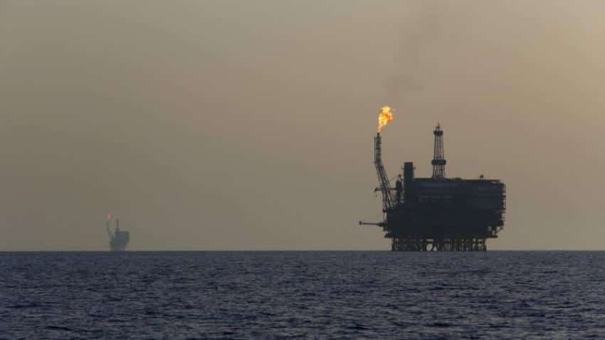 Oil prices fall over 1%, on strong dollar, Iraq output