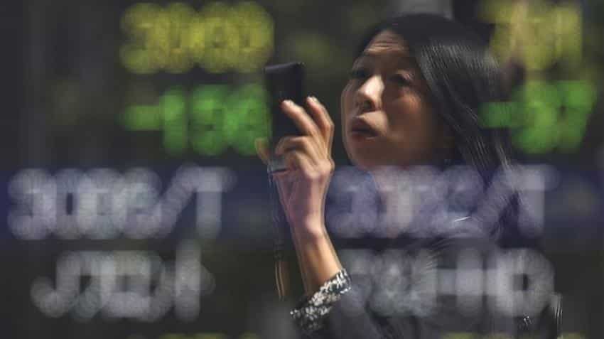 Asian stocks hold near 14-month peak on US Fed relief