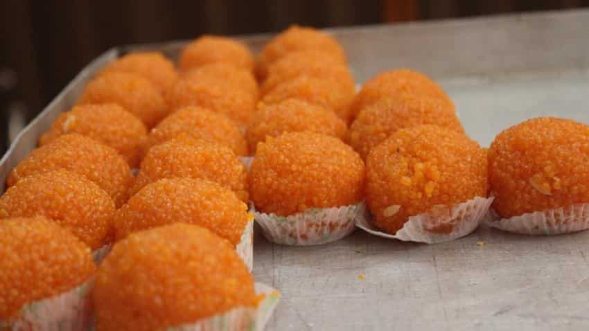 Stand in line at ATMs get a laddoo from BJP govt Stand in line at ATMs get a laddoo from BJP govt