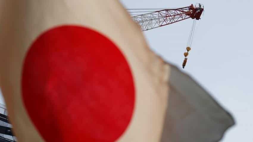Bank of Japan keeps policy on hold, brightens view of economy