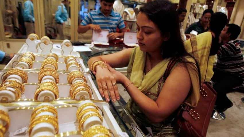 Gold futures up Rs 100 on global cues