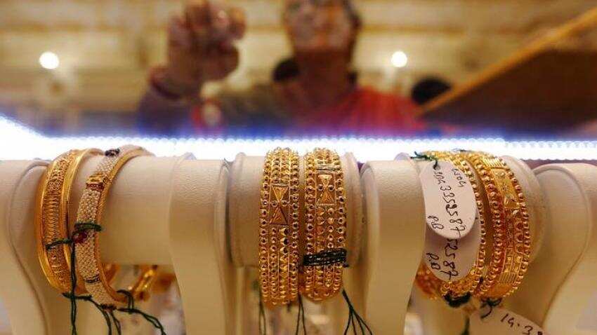 Gold hits two-week high as dollar falls after G20 trade message