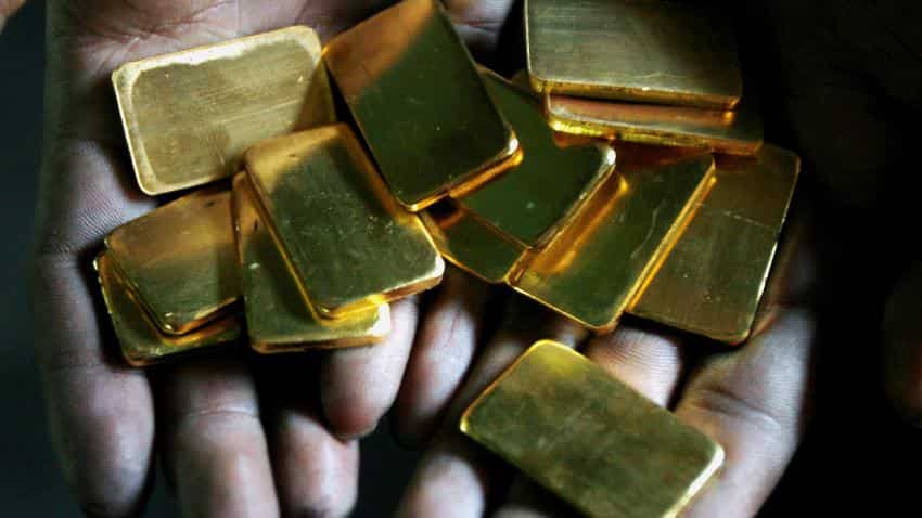 Gold retreats from five-month high as dollar rebounds