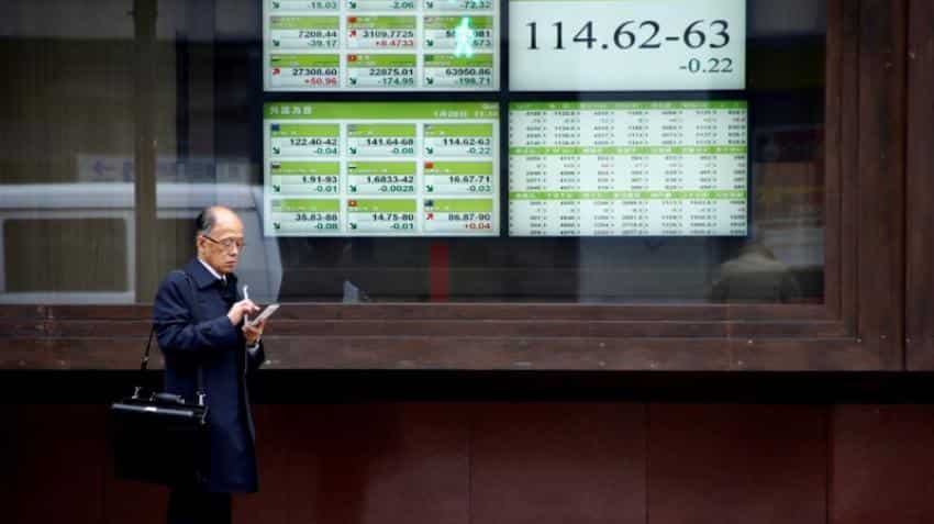 Asian shares firm, dollar and US bond yields slip after Fed