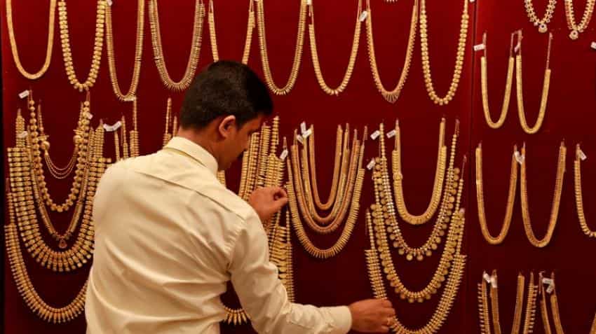 Gold holds steady as dollar eases