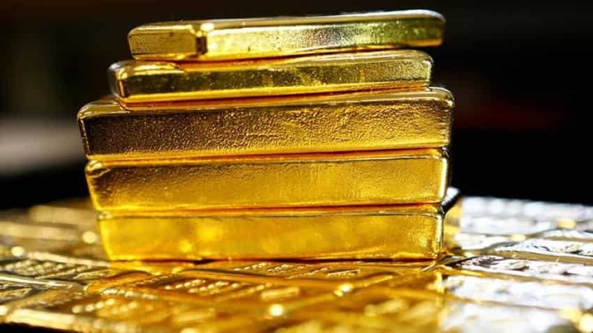 Gold inches lower as dollar holds firm on US tax bill hopes