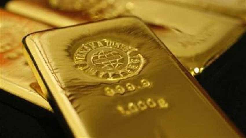 Gold edges up as dollar dips on U.S. interest rate uncertainty