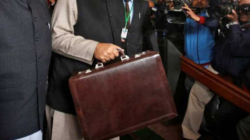 What is there in the briefcase carried by a person near to PM Modi