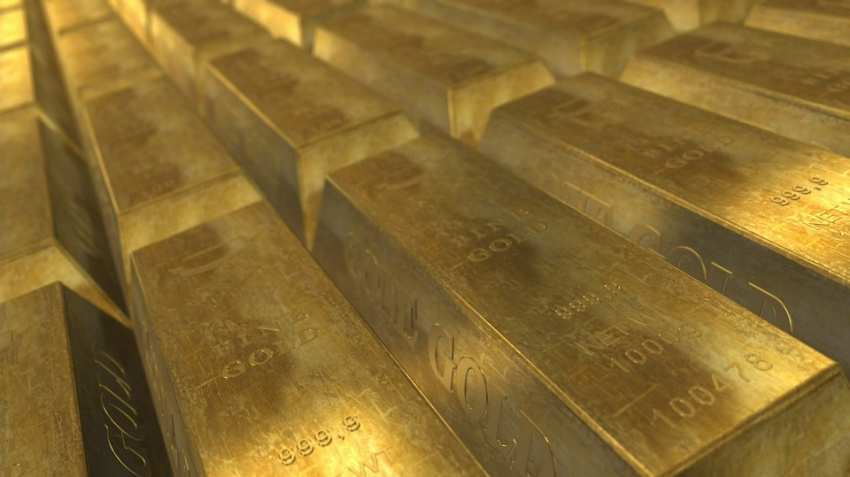 Gold holds near two-week high on dovish central banks