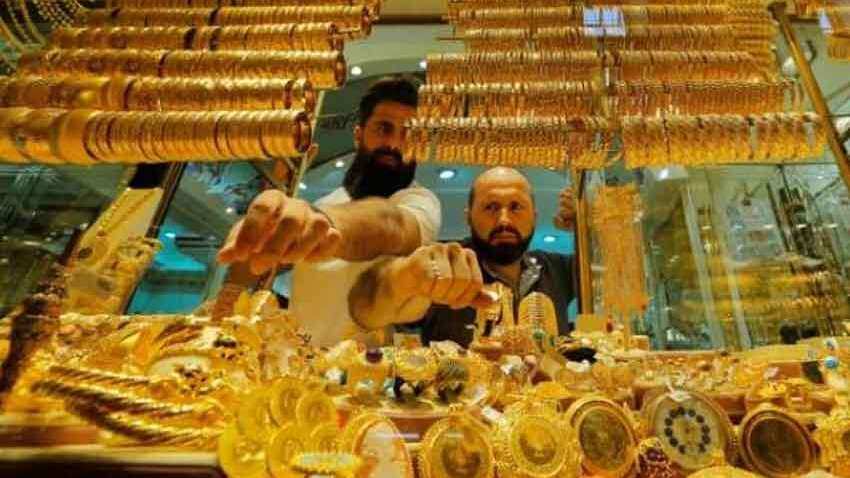 Gold price eases as dollar firms, risk appetite gains