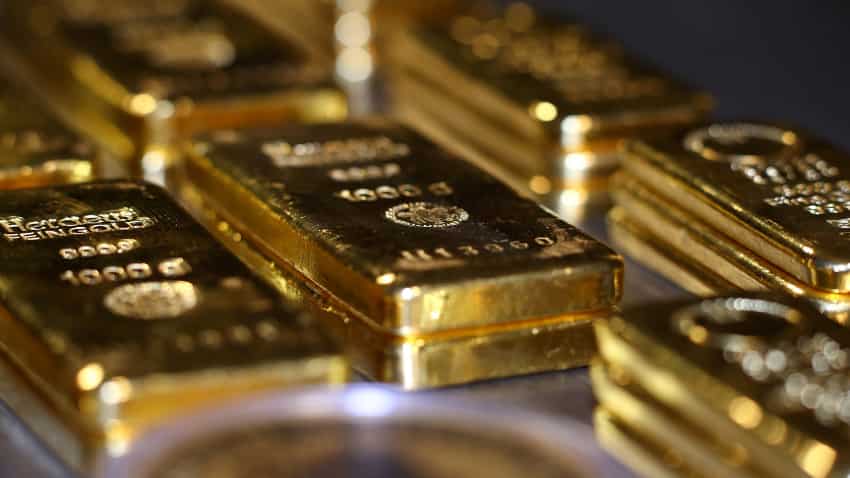 Gold rebounds as dollar dips after Fed unveils taper plan
