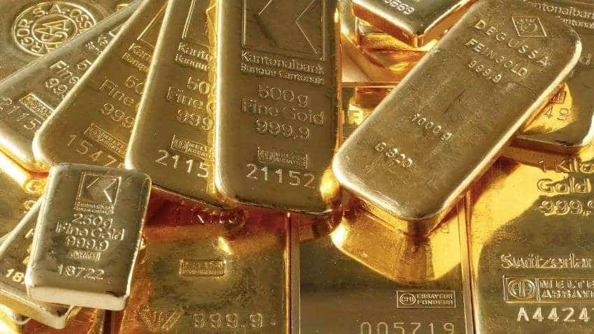 Gold eases from one-month peak as dollar and equities climb