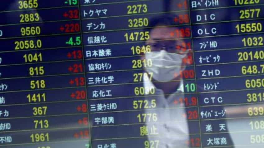 Asian stocks wobble, dollar firm as markets wary before key U.S inflation data